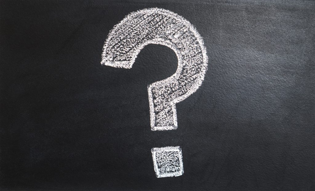 Chalked question mark on a black